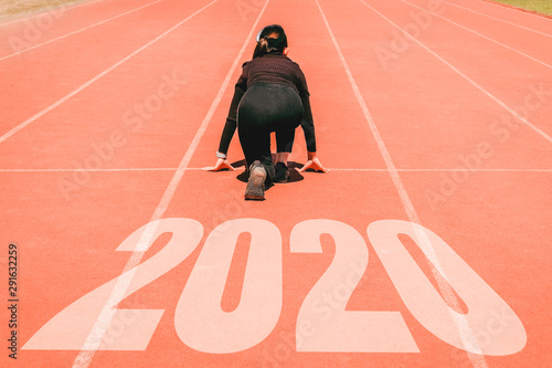 2020 Newyear , Athlete Woman starting on line for start running with number 2020 Start to new year.