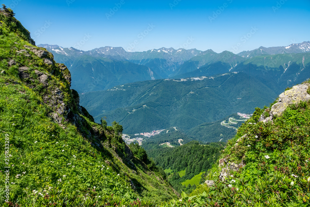 View from the heights of the Valley from residential houses, surrounded by high mountains. Krasnaya Polyana, Sochi