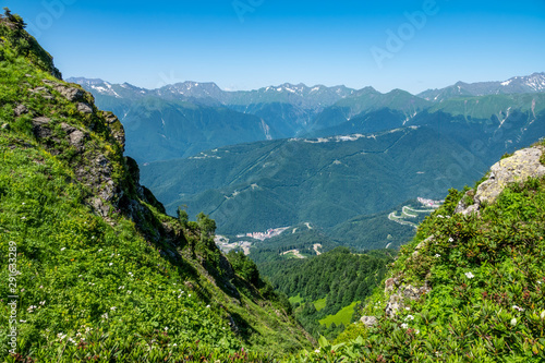 View from the heights of the Valley from residential houses, surrounded by high mountains. Krasnaya Polyana, Sochi
