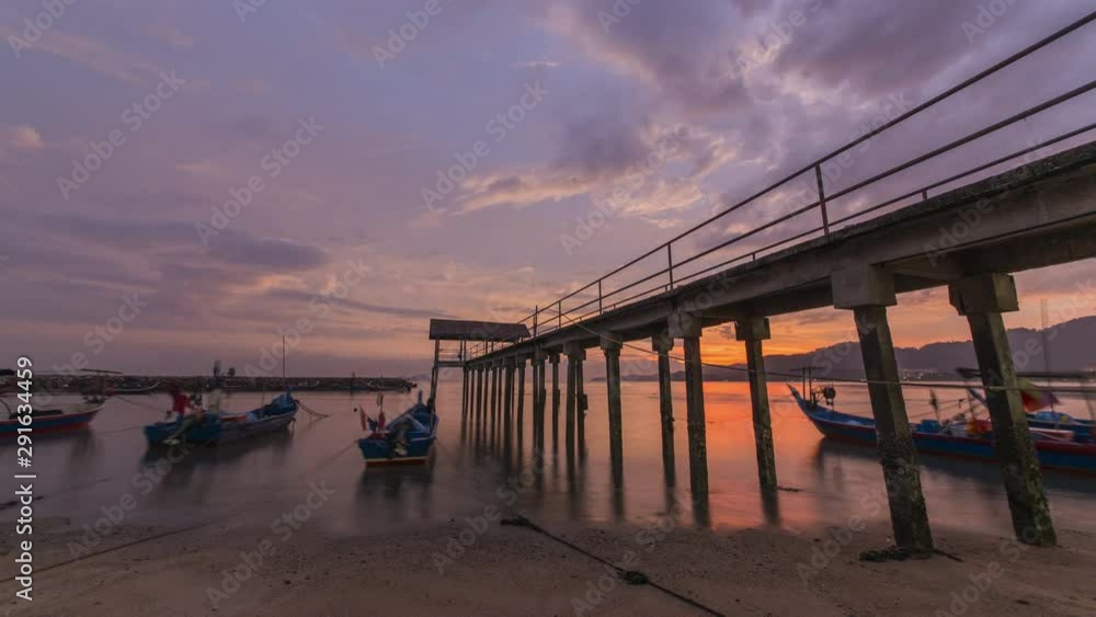 Timelapse Golden hour of sunset at fisherman village with traditional boat parking at the jetty. Timelapse Golden hour of sunset at fisherman village with traditional boat parking at the jetty.