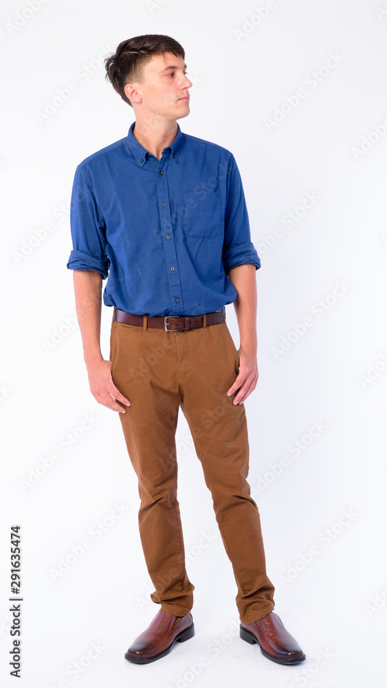 Naklejka premium Full body shot of young handsome businessman thinking and looking away