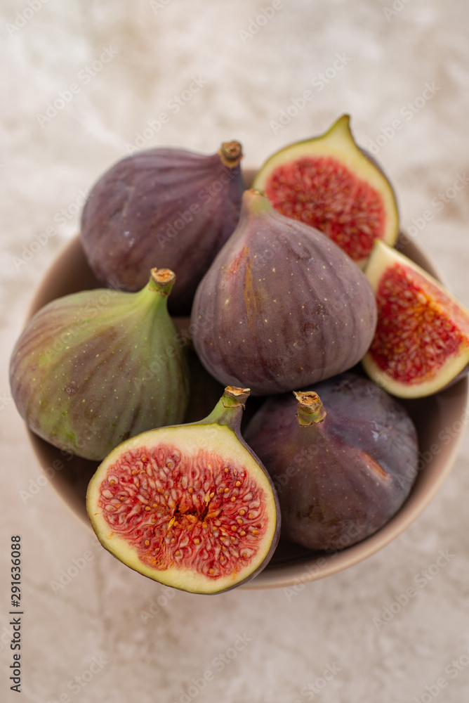 Fresh figs. Whole figs and sliced in half figs in ceramic bowl. Fresh figs. Whole figs and sliced in half figs in ceramic bowl.
