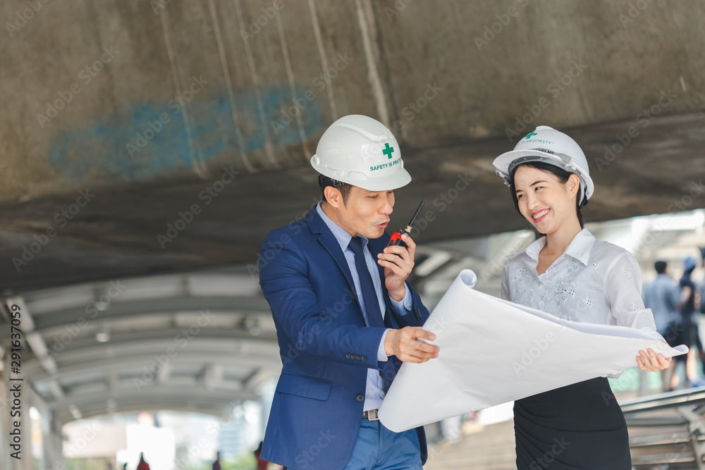 Man and women engineers with blueprint blank plan as for construction. Man and women engineers with blueprint blank plan as for construction.