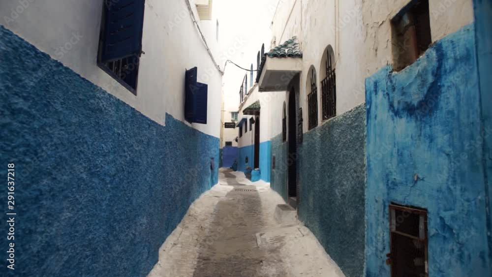 A steadicam shot of a tight street in Chefchaouen city, Morocco