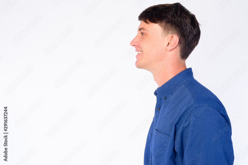 Closeup profile view of happy young handsome businessman smiling