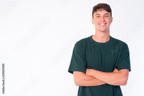 Portrait of happy young handsome man smiling with arms crossed