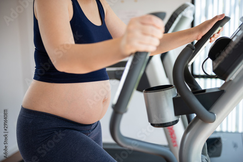 Cropped image of pregnant woman in fitness clothes exercising © mr_nutto