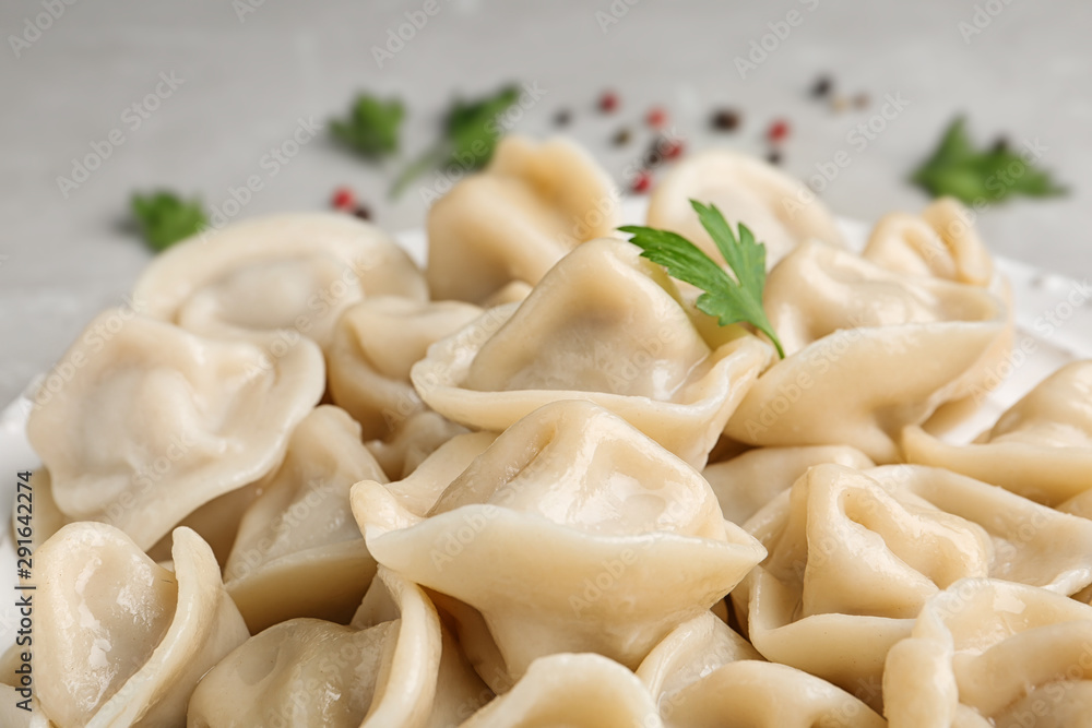 Tasty dumplings with parsley on table, closeup view Tasty dumplings with parsley on table, closeup view