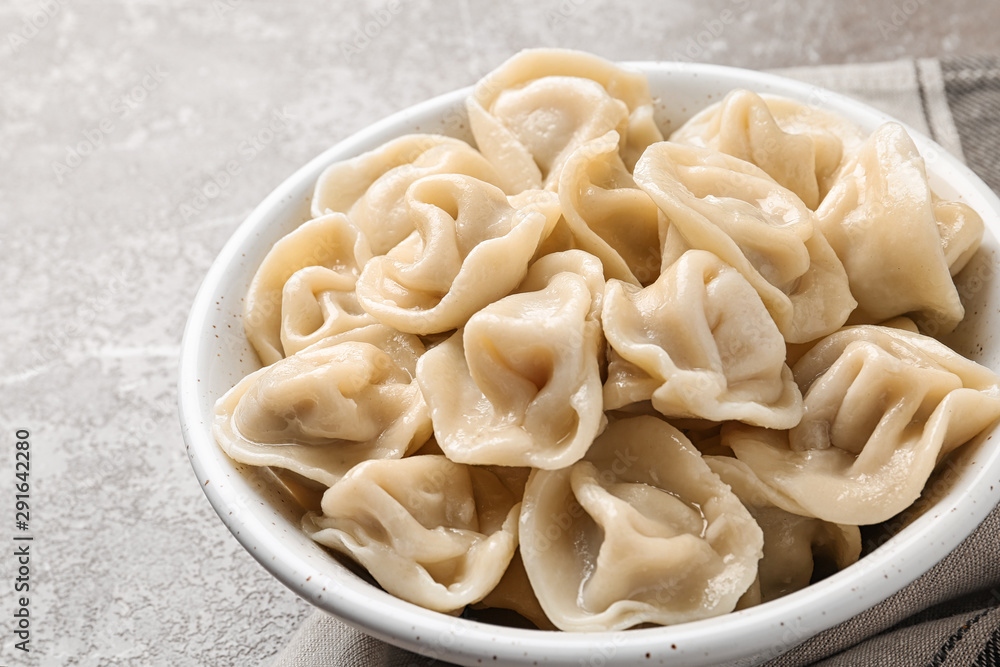 Tasty dumplings in bowl on marble table Tasty dumplings in bowl on marble table