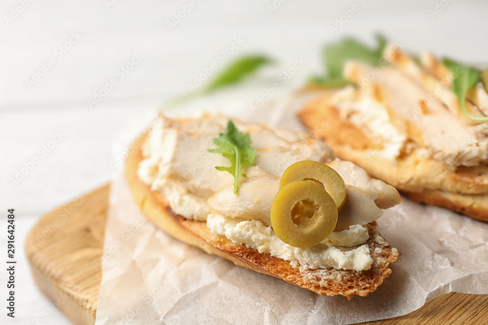 Board with delicious chicken bruschettas on white wooden table, closeup Board with delicious chicken bruschettas on white wooden table, closeup