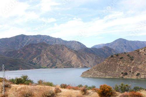 View of half of Pyramid Lake with cloudy blue sky background. Pyramid Lake offers boating, fishing, jet skiing, and picnic areas, including five unique sites that are accessible only by boat photo