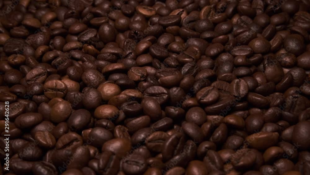 Fresh roasted coffee beans close up overhead rotating shot Fresh roasted coffee beans close up overhead rotating shot