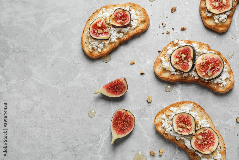 Bruschettas with cheese and figs on marble table, flat lay. Space for text Bruschettas with cheese and figs on marble table, flat lay. Space for text