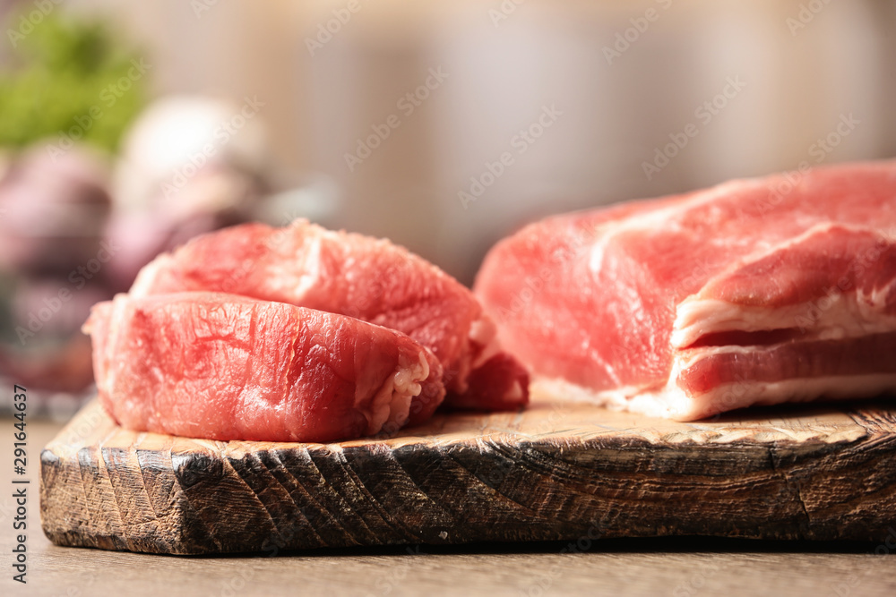 Fresh raw meat on wooden table in kitchen, closeup