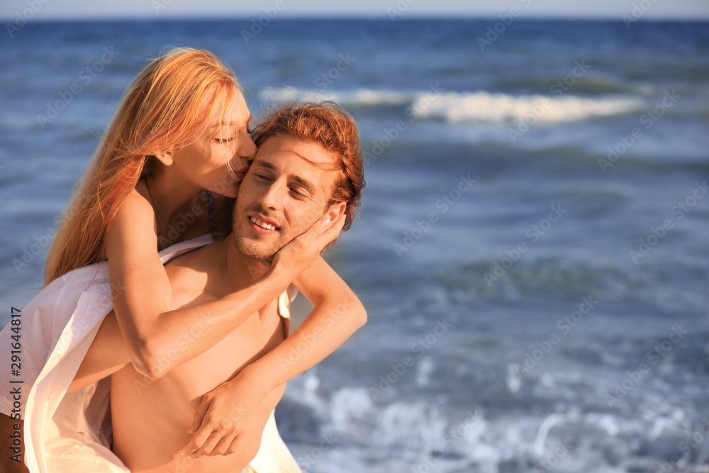 Young lovely couple on beach at sunset Young lovely couple on beach at sunset