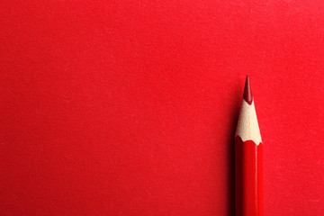 Color pencil on red background. Space for text