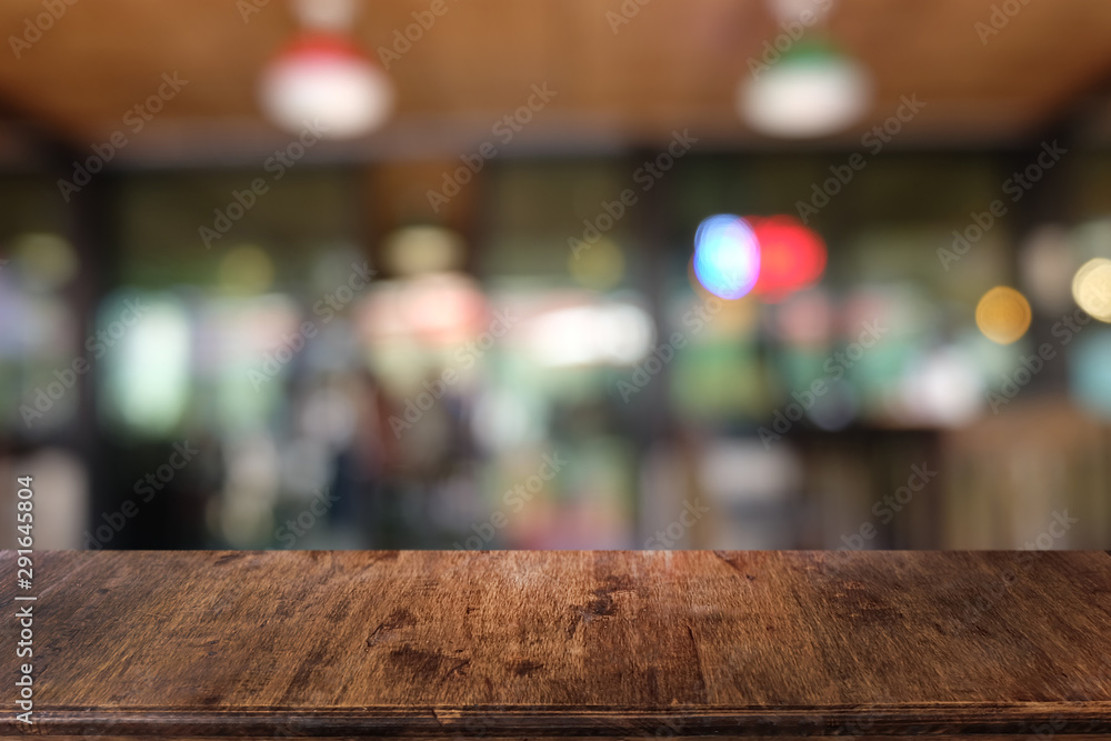 Empty dark wooden table in front of abstract blurred bokeh background of restaurant . can be used for display or montage your products.Mock up for space. Empty dark wooden table in front of abstract blurred bokeh background of restaurant . can be used for display or montage your products.Mock up for space.
