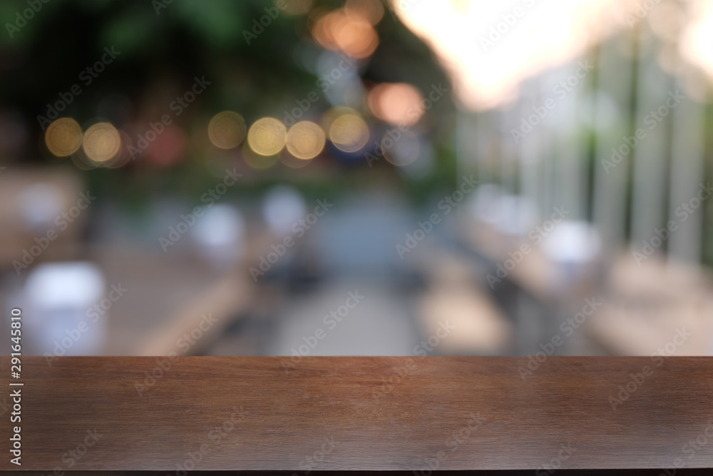 Empty dark wooden table in front of abstract blurred bokeh background of restaurant . can be used for display or montage your products.Mock up for space. Empty dark wooden table in front of abstract blurred bokeh background of restaurant . can be used for display or montage your products.Mock up for space.