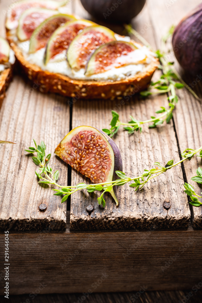 Sandwich with figs, cheese, honey and thyme. Selective focus. Shallow depth of field. Sandwich with figs, cheese, honey and thyme. Selective focus. Shallow depth of field.
