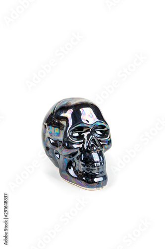 Fototapeta Naklejka Na Ścianę i Meble -  Black shiny ceramic skull figures on a blank background
