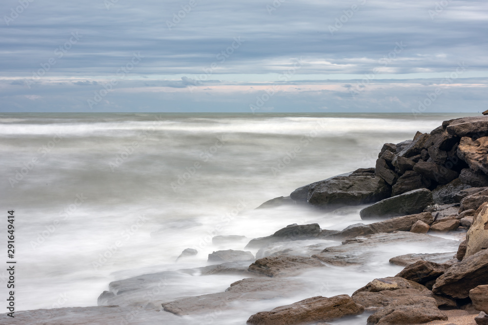 Storm in the sea, big foamy waves crash on rocks Storm in the sea, big foamy waves crash on rocks