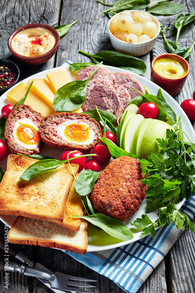 ploughman's lunch on a white platter, top view ploughman's lunch on a white platter, top view