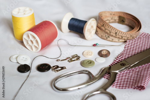 Needlework equipment on white fabric