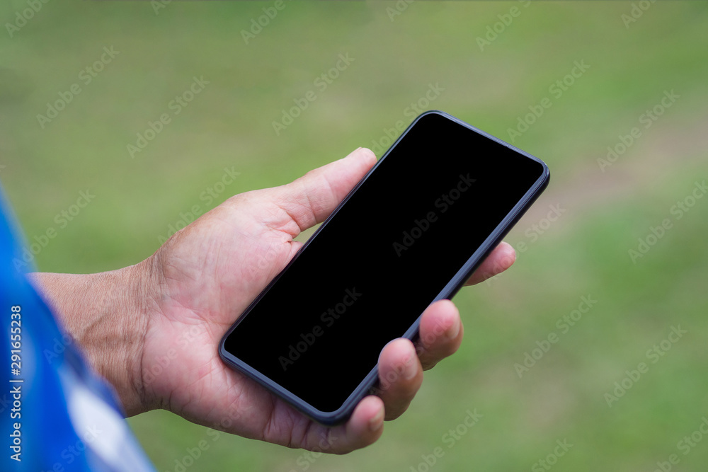 Close-up of wrinkled hand holding a smartphone