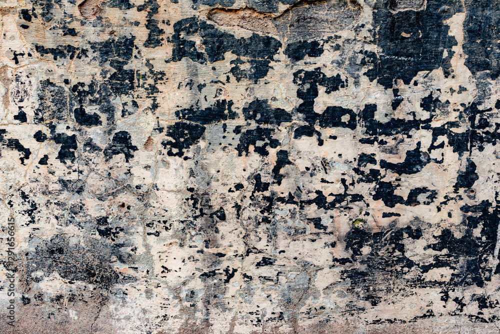 Texture of a concrete wall with cracks and scratches which can be used as a background Texture of a concrete wall with cracks and scratches which can be used as a background