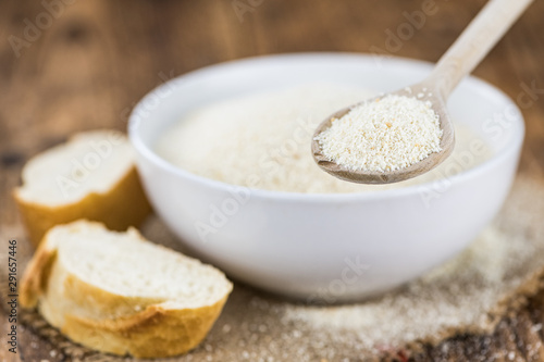 Breadcrumbs on a wooden spoon (close-up shot; selective focus)