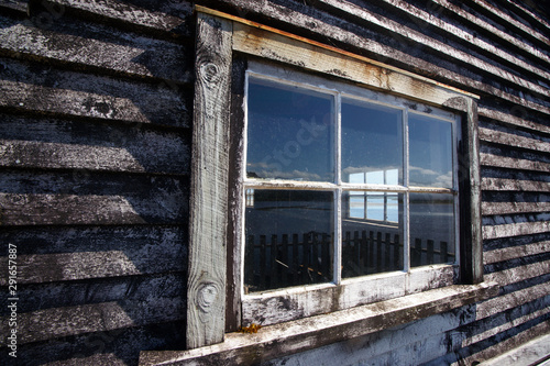 Looking through two windows in an old wooden house