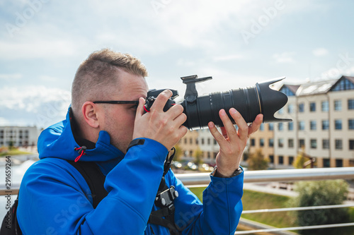 man taking photo with digital camera, professional photographer