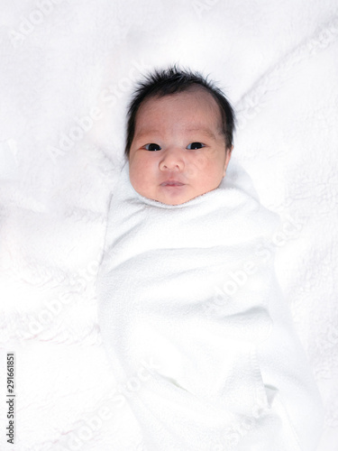 innocent baby girl with black hair and eyes