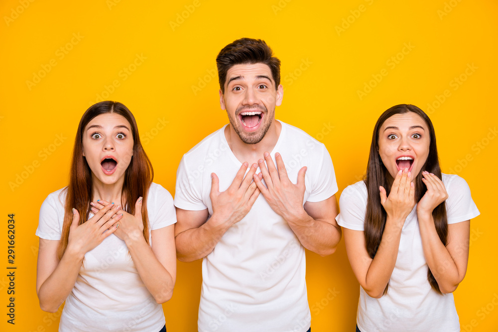 Close up photo of impressed youth screaming wow omg wearing white t-shirt isolated over yellow background Close up photo of impressed youth screaming wow omg wearing white t-shirt isolated over yellow background