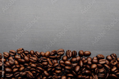 Coffee beans on wooden background. © Marijus