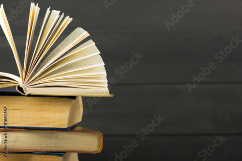 Open book, hardback books on wooden table. Back to school. Copy space