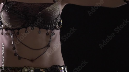 Close up of the body of a young woman in traditional dress, belly dance