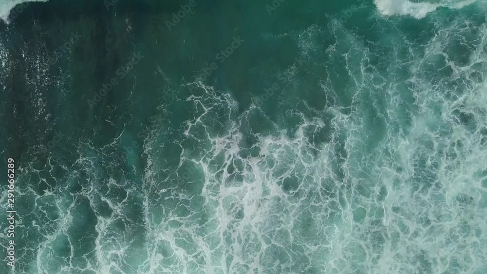 Ocean waves with foam roll on the shore, aerial view. Ocean waves with foam roll on the shore, aerial view.