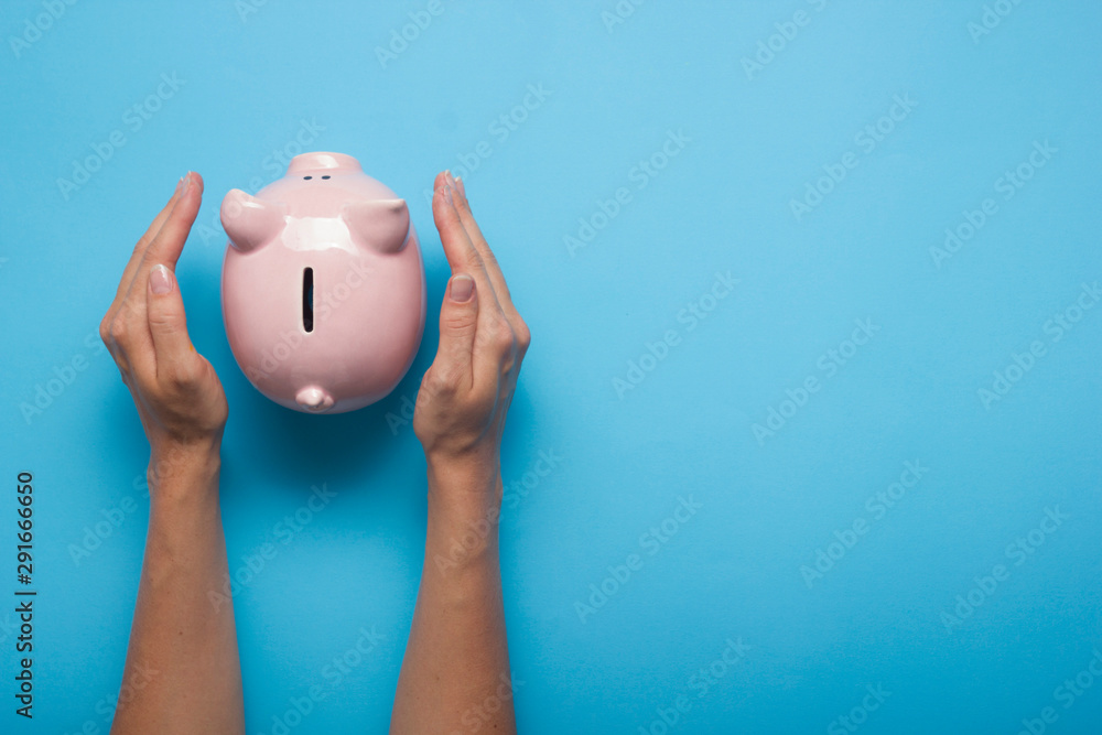 Φωτογραφία woman hand putting money coin into piggy for saving money wealth and financial c
