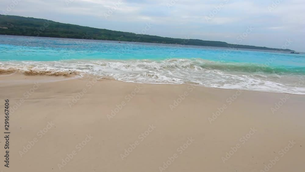 wavy blue waters in a white sand beach