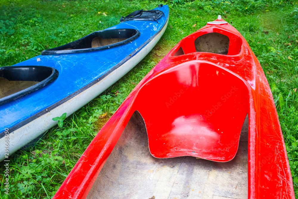 Two Kayaks Placed Together For Drying on Grass Outdoors