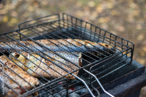 Spiced Mullet Seafood Preparing on Grill Outdoors.