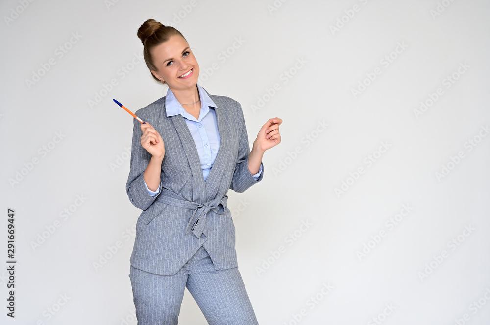 Portrait of a beautiful manager girl in a gray business suit on a white background. He is talking in different poses with emotions. Portrait of a beautiful manager girl in a gray business suit on a white background. He is talking in different poses with emotions.