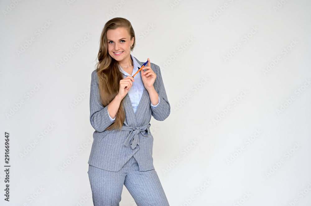 Portrait of a beautiful manager girl in a gray business suit on a white background. He is talking in different poses with emotions. Portrait of a beautiful manager girl in a gray business suit on a white background. He is talking in different poses with emotions.