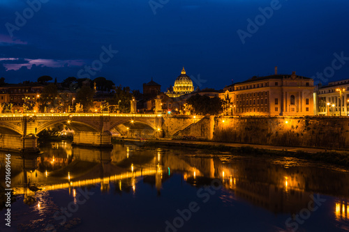 View over river tiber to Saint peters basilica in rome by night