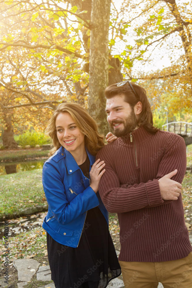 Fototapeta premium Couple in the park enjoying nice autumn time.