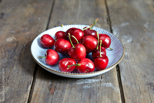 cherries in a bowl on wooden table