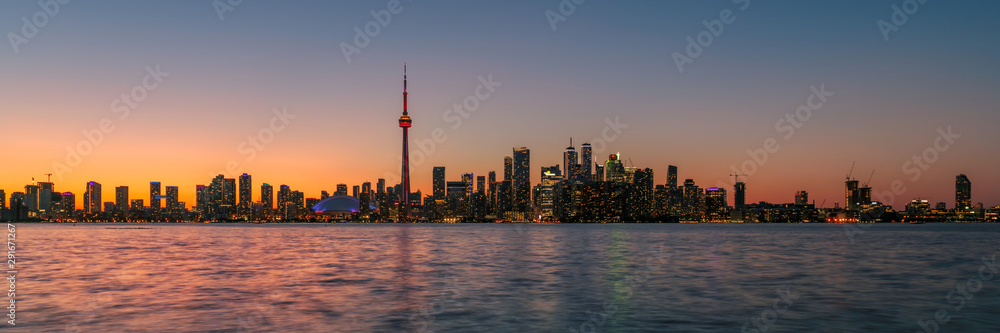 Panorama of Toronto at sunset with CN Tower over Ontario Lake, Canada