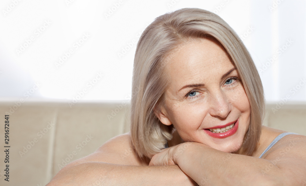 Fifty year old woman is very pleased with her well-groomed face. Plastic surgery collagen injections. Macro face. Selective focus on face. Realistic images with their own imperfections. Fifty year old woman is very pleased with her well-groomed face. Plastic surgery collagen injections. Macro face. Selective focus on face. Realistic images with their own imperfections.