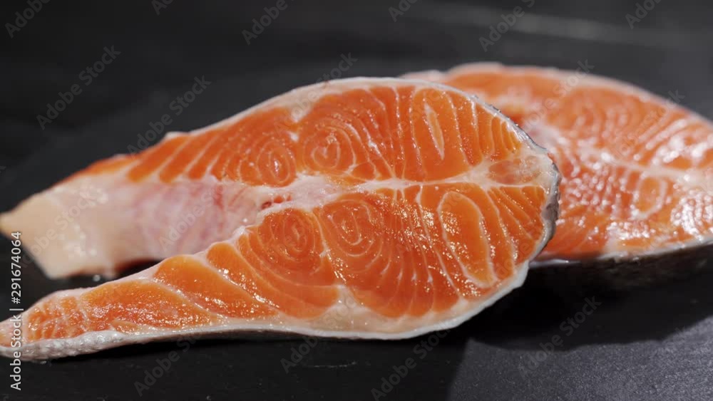 Salmon. Raw Trout Red Fish Steak with Herbs and Lemon and olive oil on slate. Salmon. Raw Trout Red Fish Steak with Herbs and Lemon and olive oil on slate.